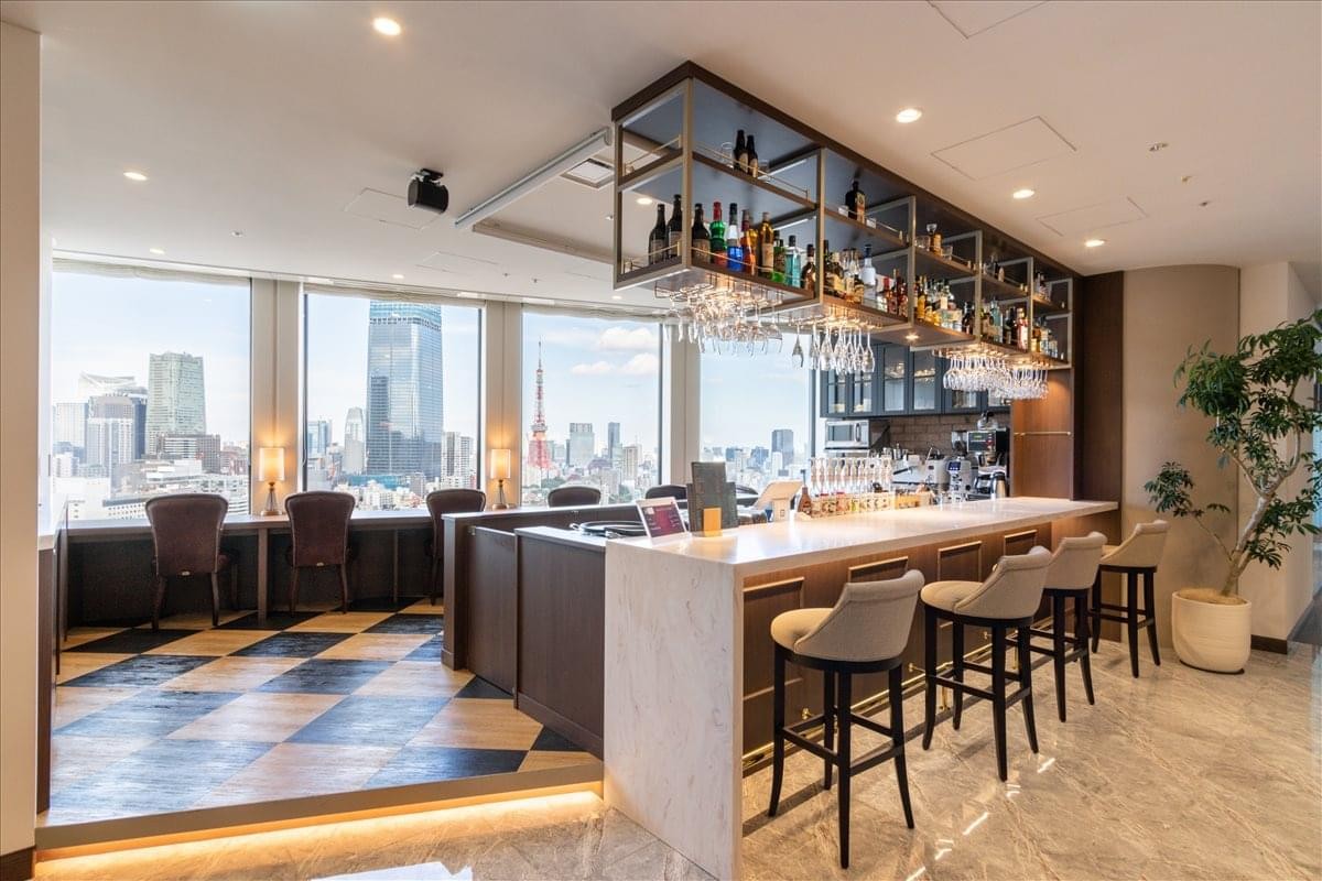Upscale bar and café area at Roppongi Hills Mori Tower 11F with high stools and panoramic city views.