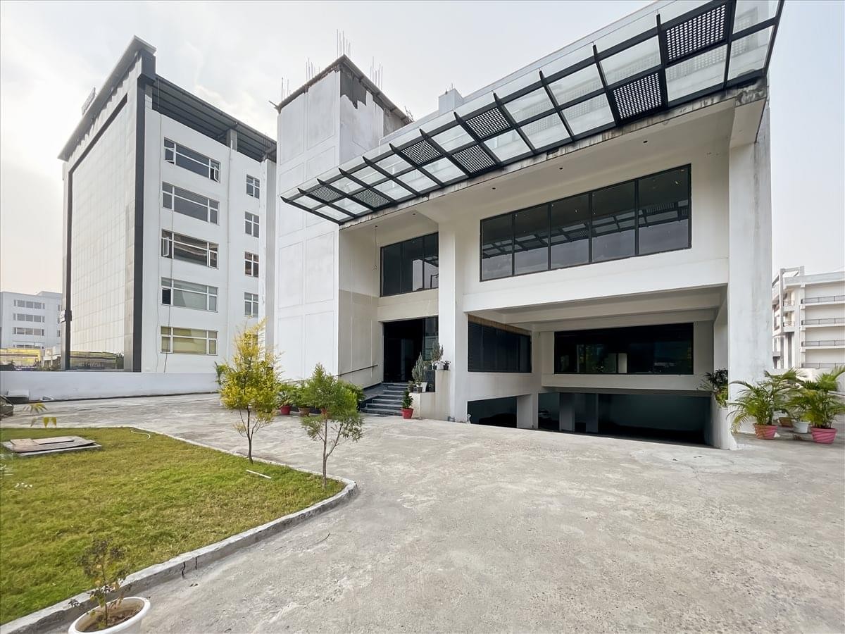 Exterior view of the white 44A IT Park office building with a modern glass facade.