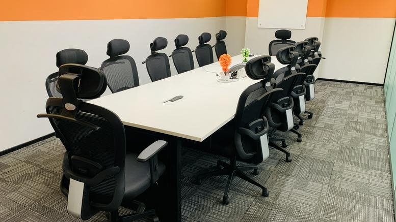 Professional meeting room at Sanali Spazio, Level 15, Software Unit Layout with a white table and black mesh chairs.