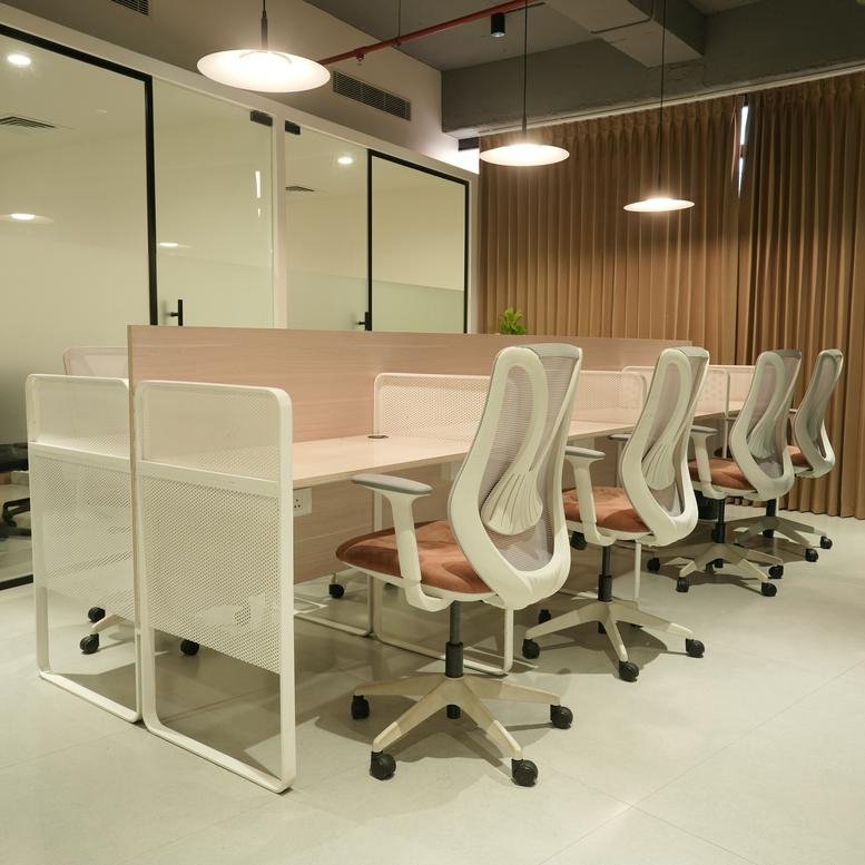 Sandbox, 1408, 4th Floor, Tower 1, Kozhikode features a row of ergonomic chairs and bright pendant lighting.