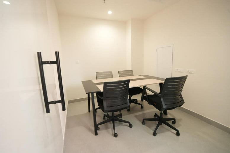 Sandbox, 1408, 4th Floor, Tower, 1, Kozhikode features a minimalist four-person internal meeting room.