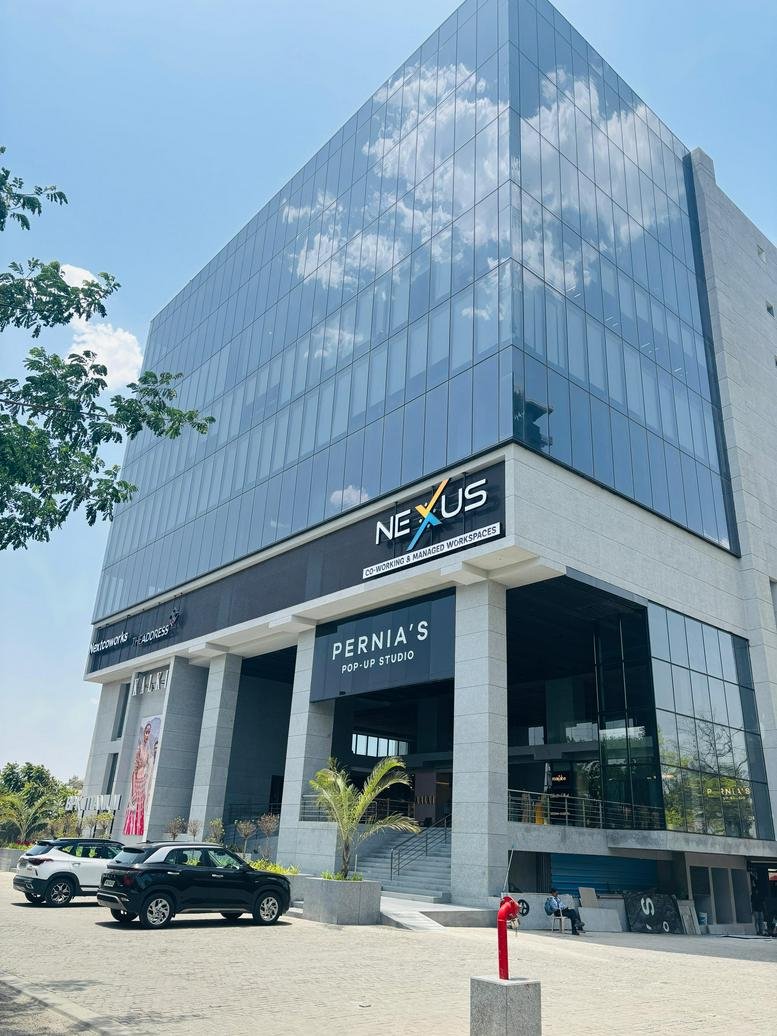 Exterior view of the glass-facade Nexus building at Scheme No 78, III, Indore.