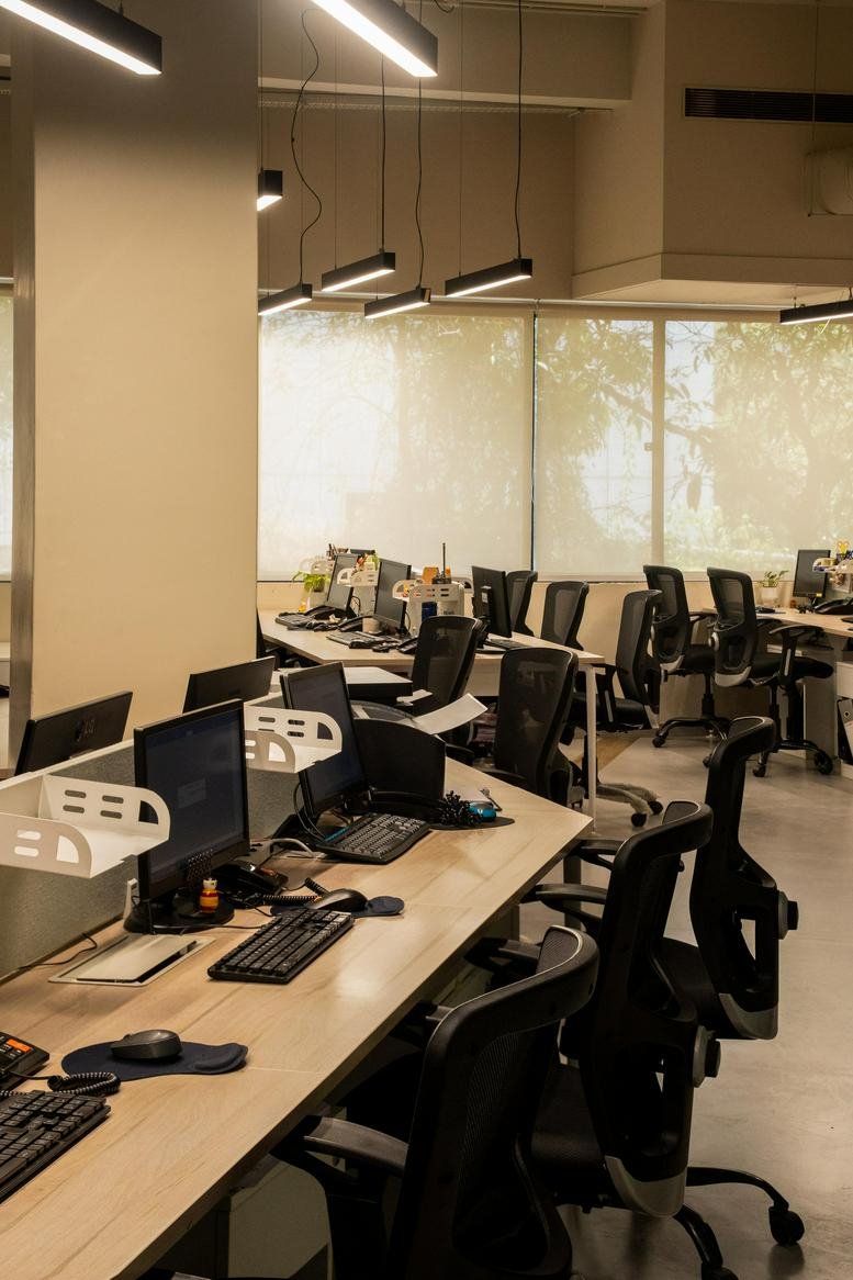 Open-plan workspace at Brady Glady’s Plaza featuring rows of desks and modern lighting.