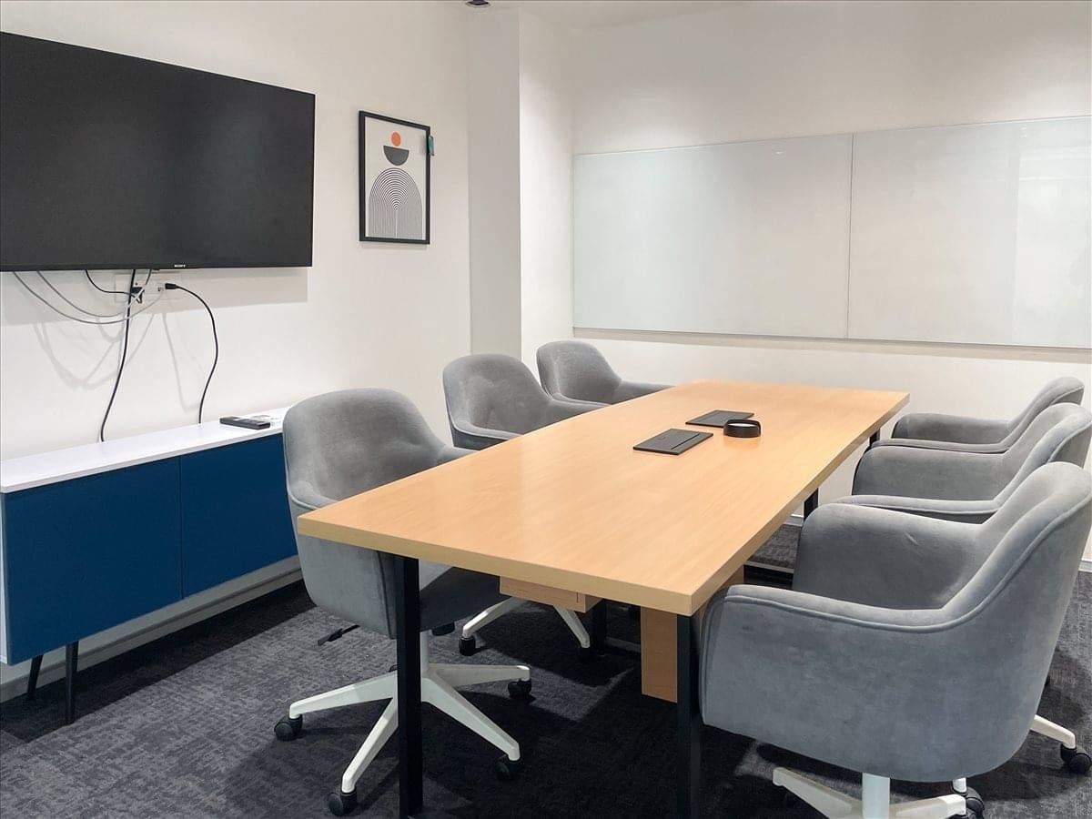 Professional meeting room at Site3, Timber Market, Sector 26, Chandigarh with a light wood table and grey chairs.