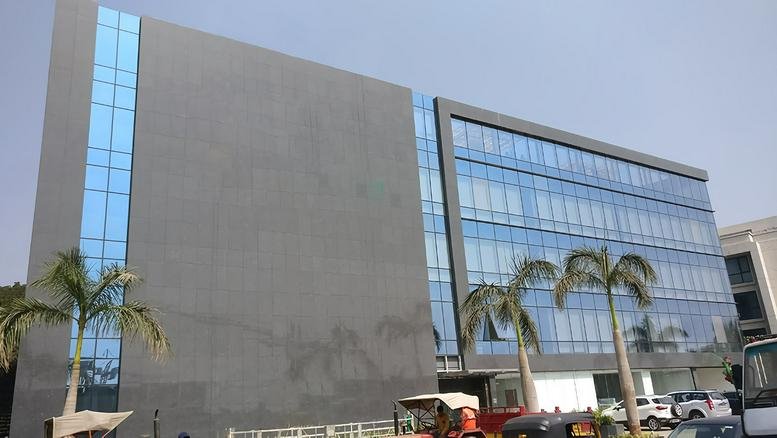 Modern glass and grey facade of the Sky Belvedere office building.