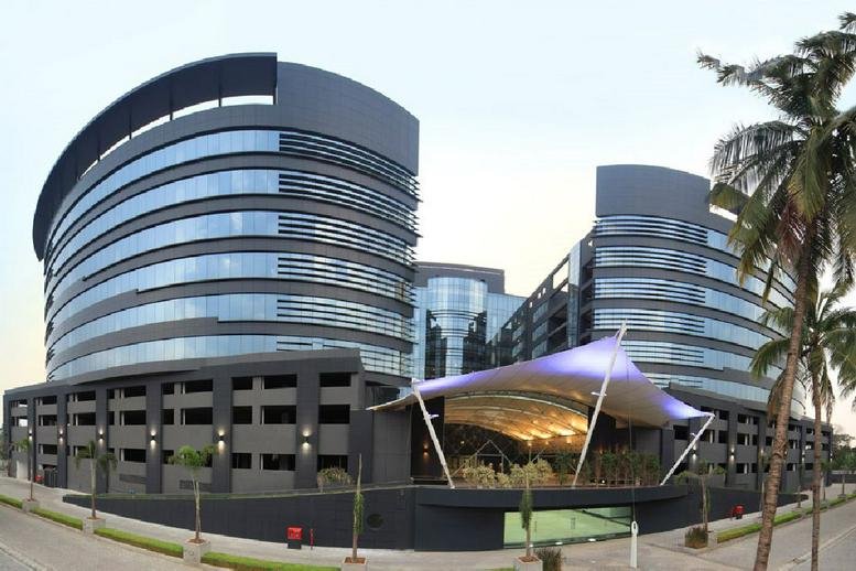 Modern exterior view of the curved glass-facade Skyrise building in Pimpri Colony.
