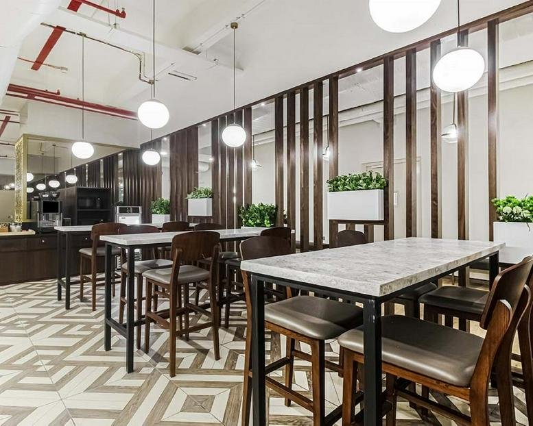 Soul Space Paradigm, 1st & 2nd Floor, Outer Ring Road breakout area with high marble tables and wooden chairs.