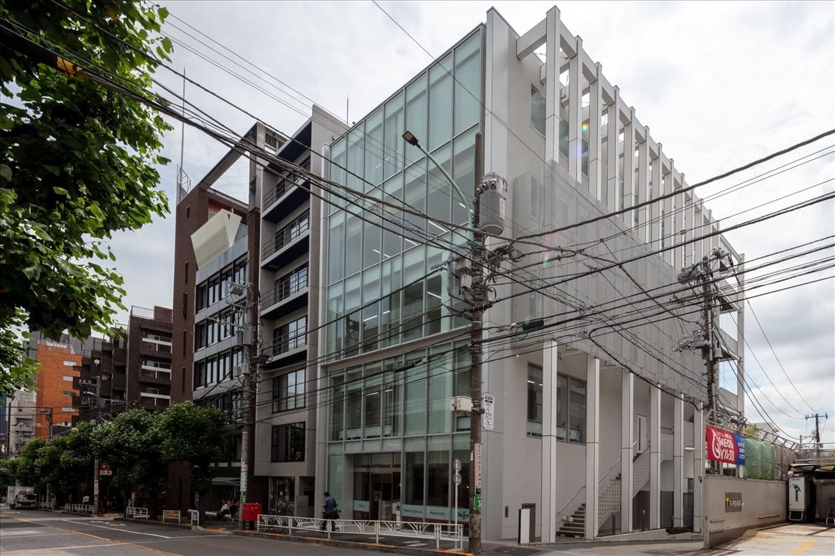 Exterior view of the modern glass and concrete facade of the Square Daikanyama building.