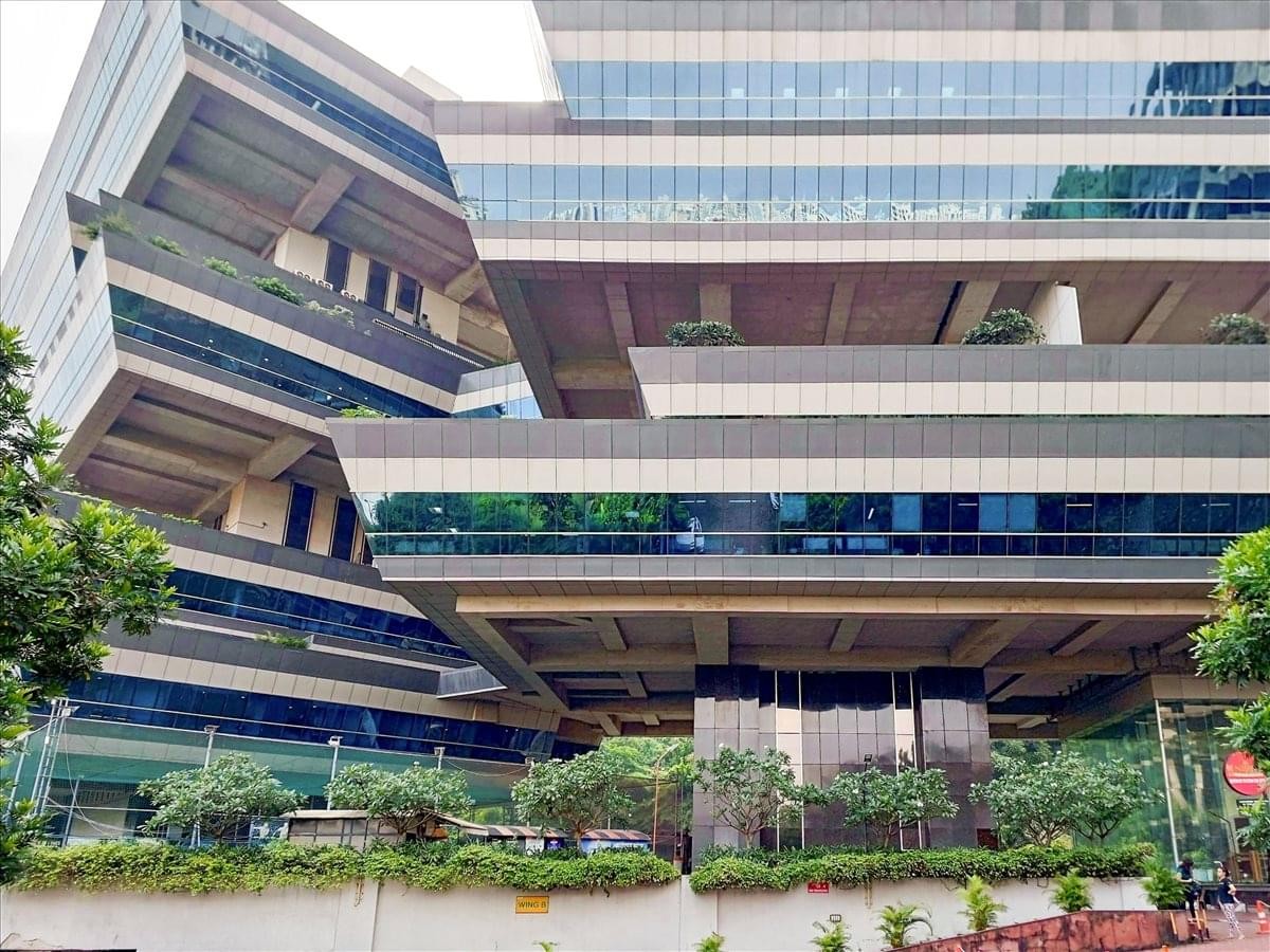 Modern exterior facade of Supreme Business Park with geometric balconies and glass windows.