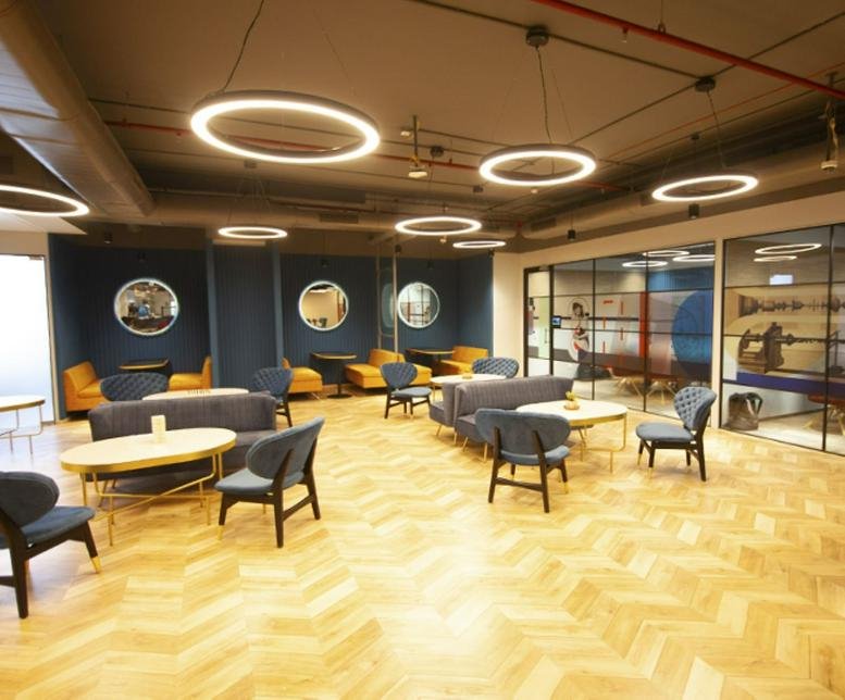 Spacious lounge area with wood floors and circular pendant lights at 1st – 4th Floor, Survey No 34, Kothaguda Junction.