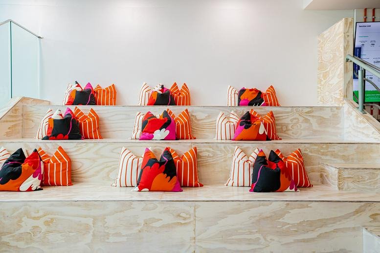Tiered seating area with colorful cushions.