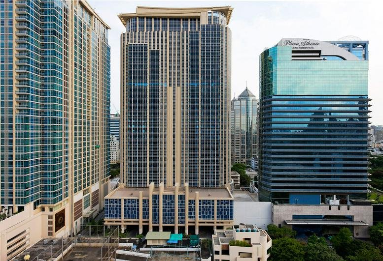 Exterior view of the towering Athenee Tower facade in the heart of Bangkok.
