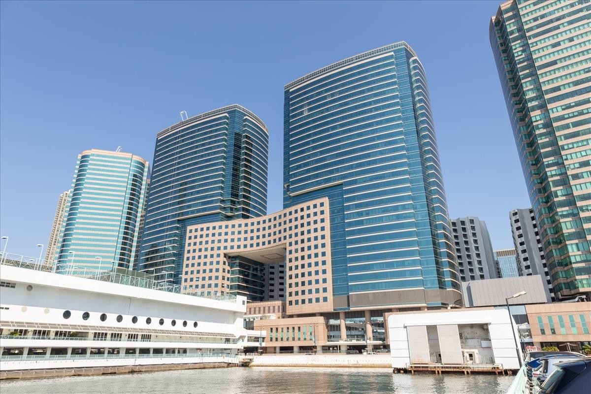 Exterior view of the glass-facade The Gateway Tower 5 building overlooking the water.