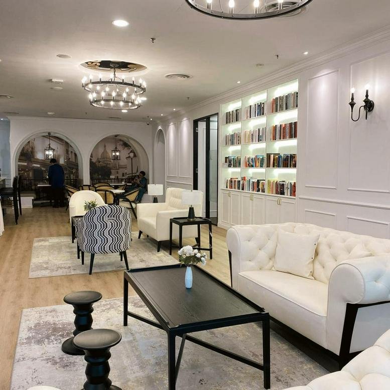 Spacious communal lounge at The Horizon, Level 7, Tower 7, Menara Pernas, Kuala Lumpur with white sofas and bookshelves.