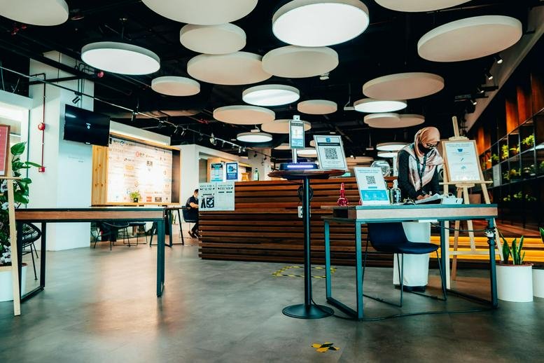 Spacious reception area at The Starling Mall featuring a wood-paneled desk and circular ceiling lighting.
