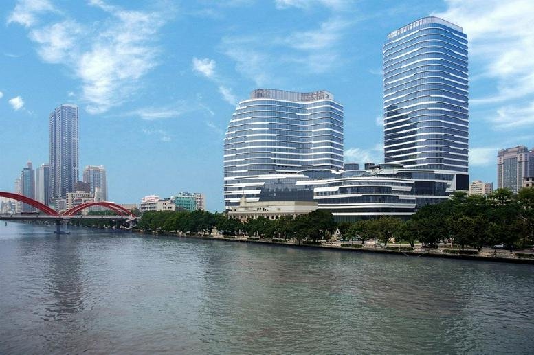 Exterior view of the modern glass-facade Tower 2, Lumina Guangzhou overlooking the river.