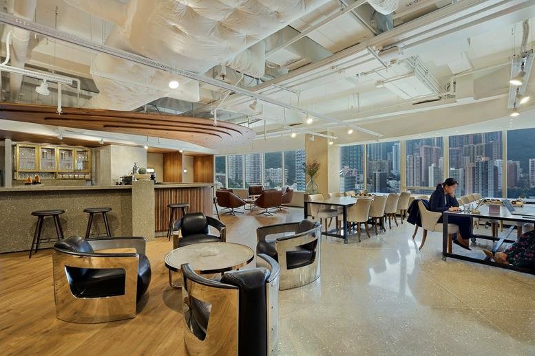 Spacious communal lounge at Two Pacific Place with bar seating and city views through large windows.