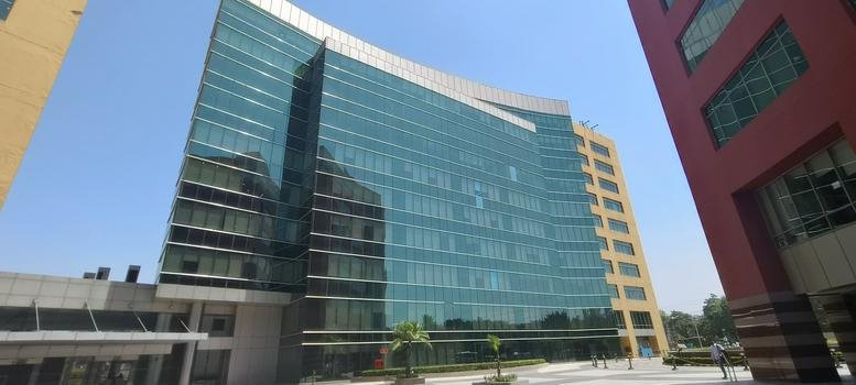 Exterior view of the glass-facade Unitech Cyber Park, Tower D in Gurugram.