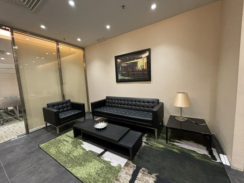 Formal boardroom with a long wood table and framed artwork on the walls.