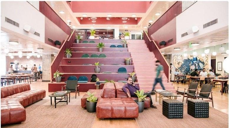 Spacious communal lounge at Vi-John Tower 393 with tiered seating and leather sofas.