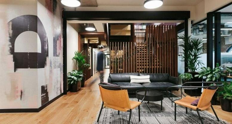 Spacious lounge area at WeWork Li & Fung Plaza, 2000 Yishan Rd, Shanghai with leather sofas and wooden accents.