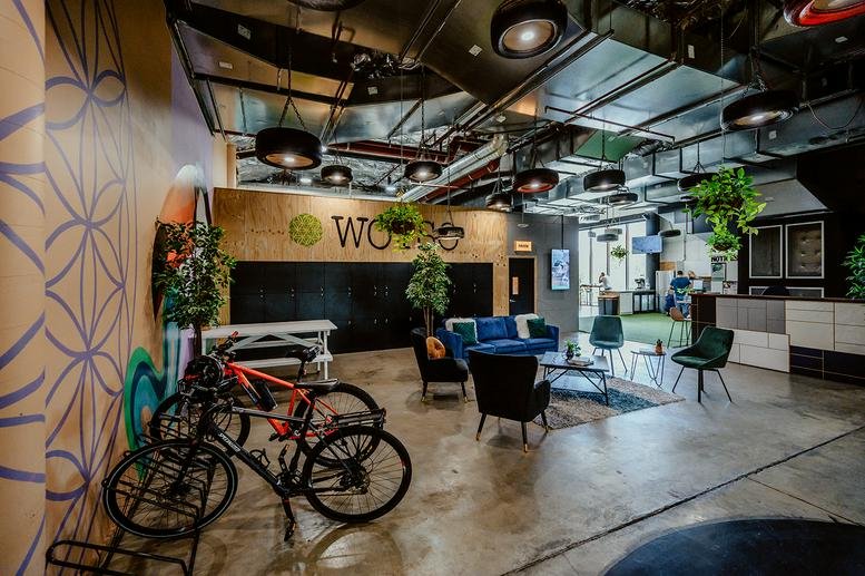 Spacious communal lounge at WOTSO Chermside, Level 2 Westfield Chermside, Brisbane, with blue sofas and plants.