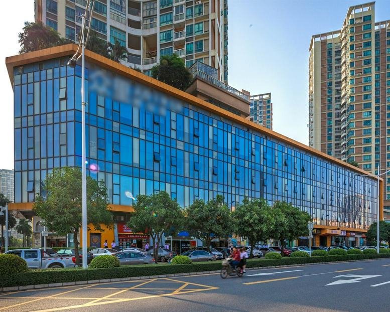 Modern glass-facade exterior of the Yujingwan Business Building No. 31 with street-level retail.