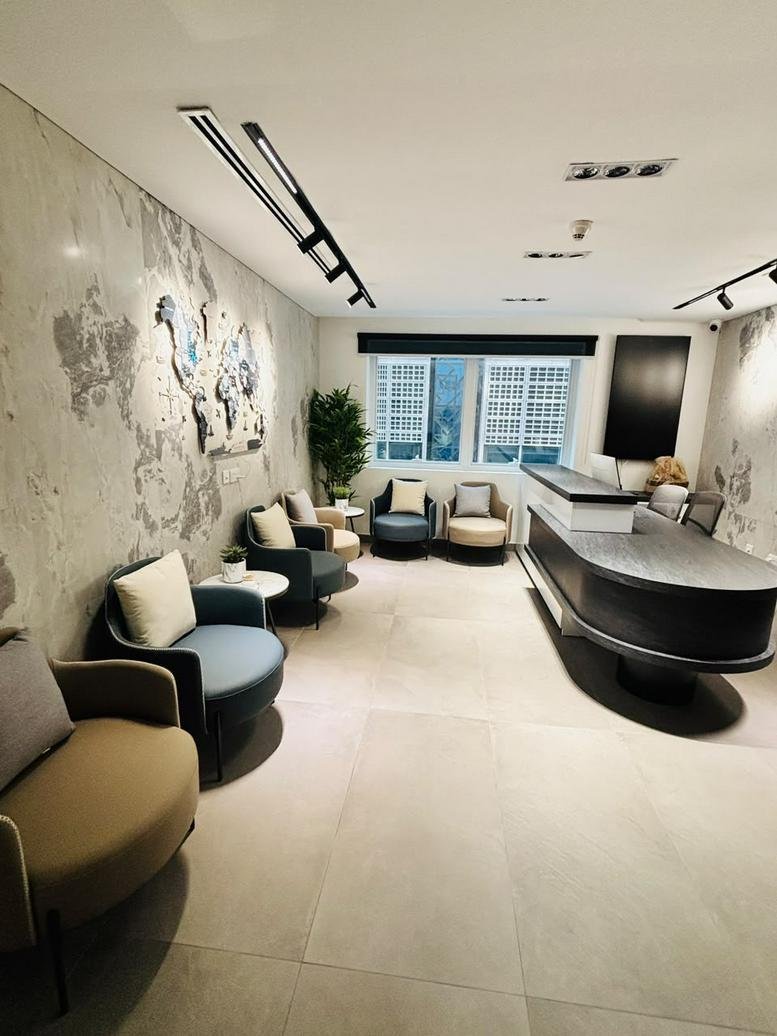 Modern reception and lounge at Sheikh Rashid Bin Saeed Street with a world map wall feature and plush seating.