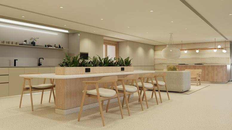 Spacious communal lounge and kitchen area at Silvercord Tower 1 with light wood finishes and indoor plants.