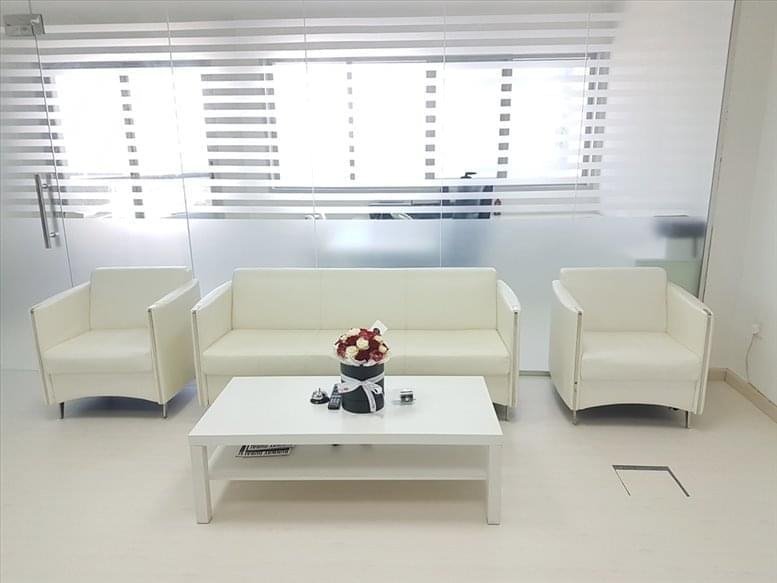 Spacious reception lounge at Barsha Heights, Tecom, Dubai with white leather sofas and frosted glass accents.