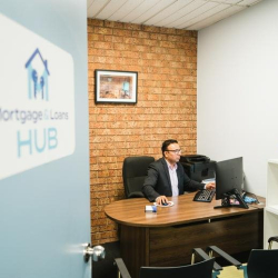 Private office suite at 44 Watton Street featuring a brick feature wall and professional desk setup.