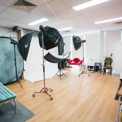 Professional photography and media studio equipped with backdrops and lighting gear.