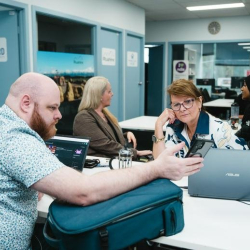 Shared office environment showing professionals working in a communal space.