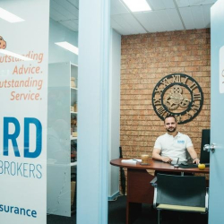 View into a private office suite through glass partitioning with corporate signage.