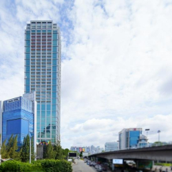 Wide exterior view of the modern glass-facade skyscraper and surrounding cityscape