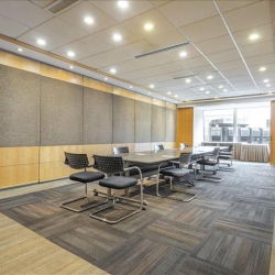 Spacious boardroom with a long conference table and gray chairs, Wan Chai, Hong Kong.