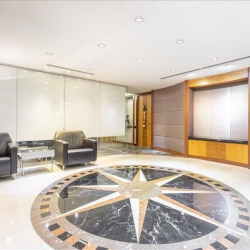 Reception lobby with distinctive star floor pattern and armchairs, Central Plaza, Wan Chai, Hong Kong.