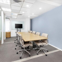 Large conference room with wooden table and wall-mounted screen at 41A Ly Thai To, Hanoi.