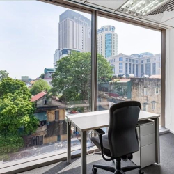 Private office featuring a desk and chair with views of trees, Hanoi, Vietnam.