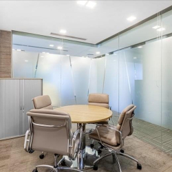Small meeting room with round table and glass partitions at 41A Ly Thai To, Hanoi.