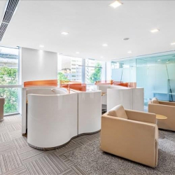 Modern office lobby lounge with white curved pods and tan seating, Hanoi, Vietnam.