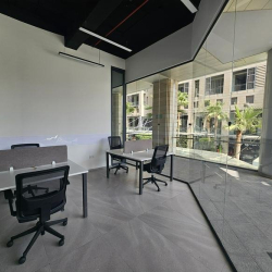 Modern two-person office with grey partitions and a window view.