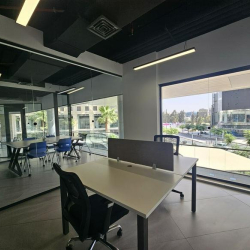 Small private office with a desk and a glass door to the corridor.