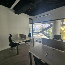 Minimalist office desk with a grey divider and building views.