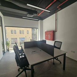Sleek workspace with glass partitions and modern light fixtures.