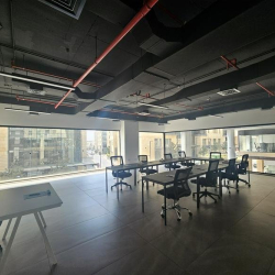 Professional workspace with desks and views of the surrounding city.