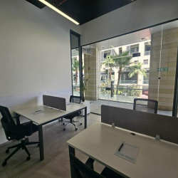 Coworking area featuring desks with grey privacy partitions.