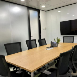 Spacious boardroom with wooden table and video conferencing screen, Tsim Sha Tsui, Hong Kong