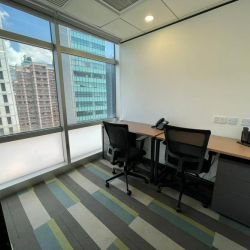 Private office suite with floor-to-ceiling windows overlooking Tsim Sha Tsui, Hong Kong