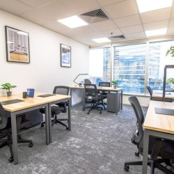 Bright private office space with wooden desks and ergonomic chairs, Causeway Bay, Hong Kong.